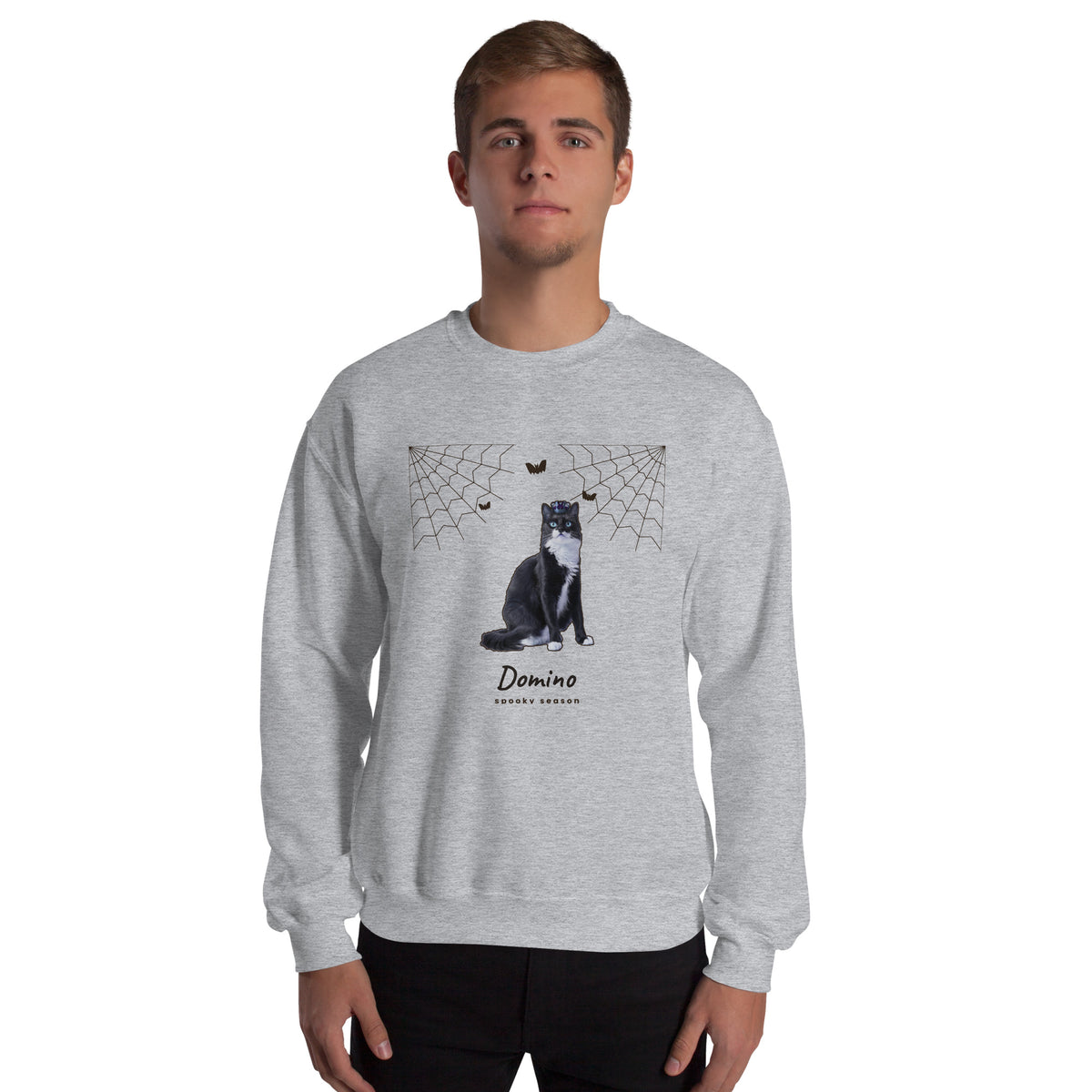 Man wearing a Sport Grey personalized Halloween crewneck with a cat and cobweb design