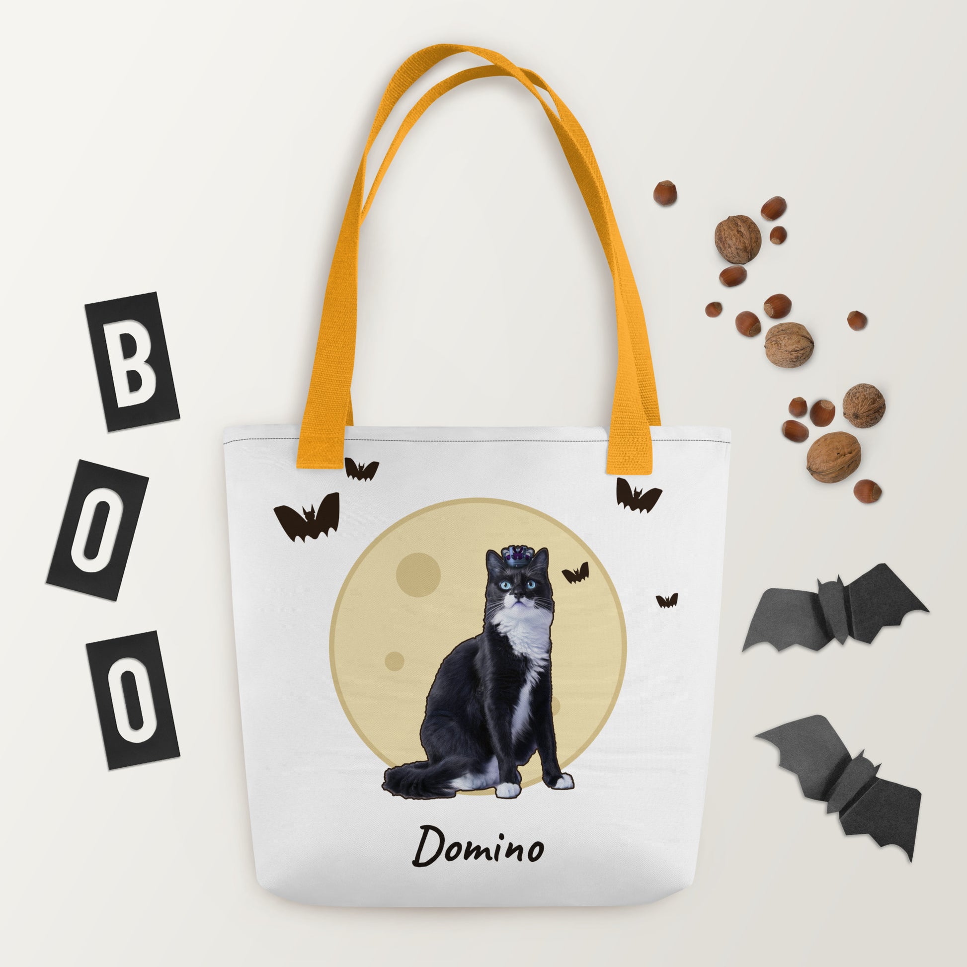 Personalized Halloween tote with a cat under a full moon, styled flat with paper bats